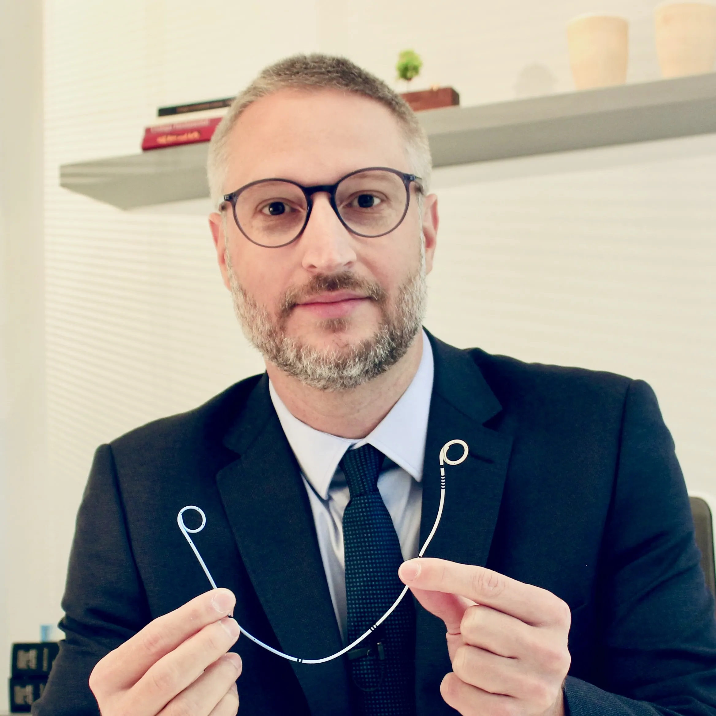 Dr. Daniel Hampl segurando um cateter duplo J no consultório